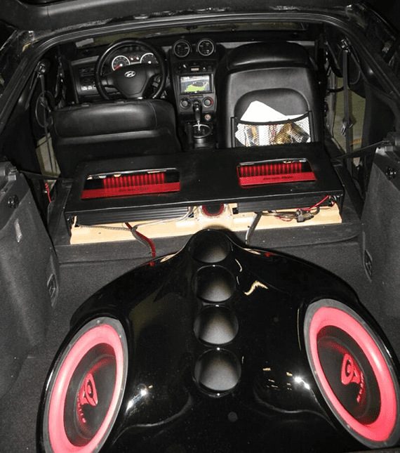 Car trunk with custom audio equipment and subwoofers.